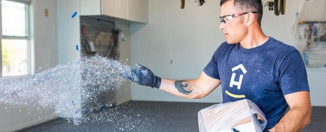 Hello Garage technician applying specks to garage floor