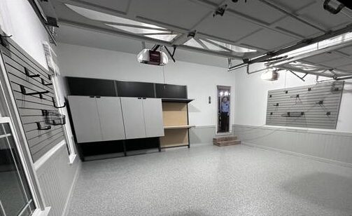 Garage with multiple cabinets and new flooring