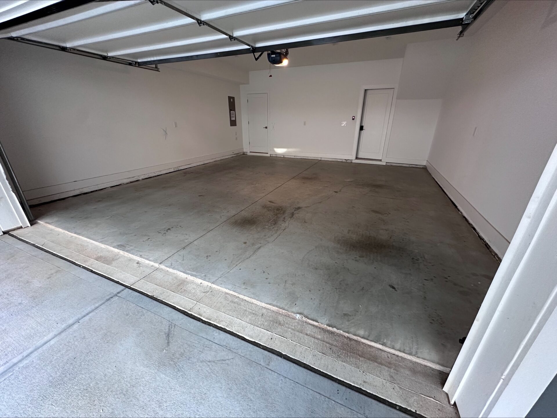 Stained, bland garage concrete floor