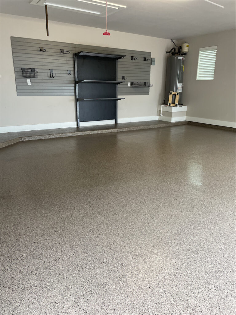 Organized Garage with a shelving unit and slatwall