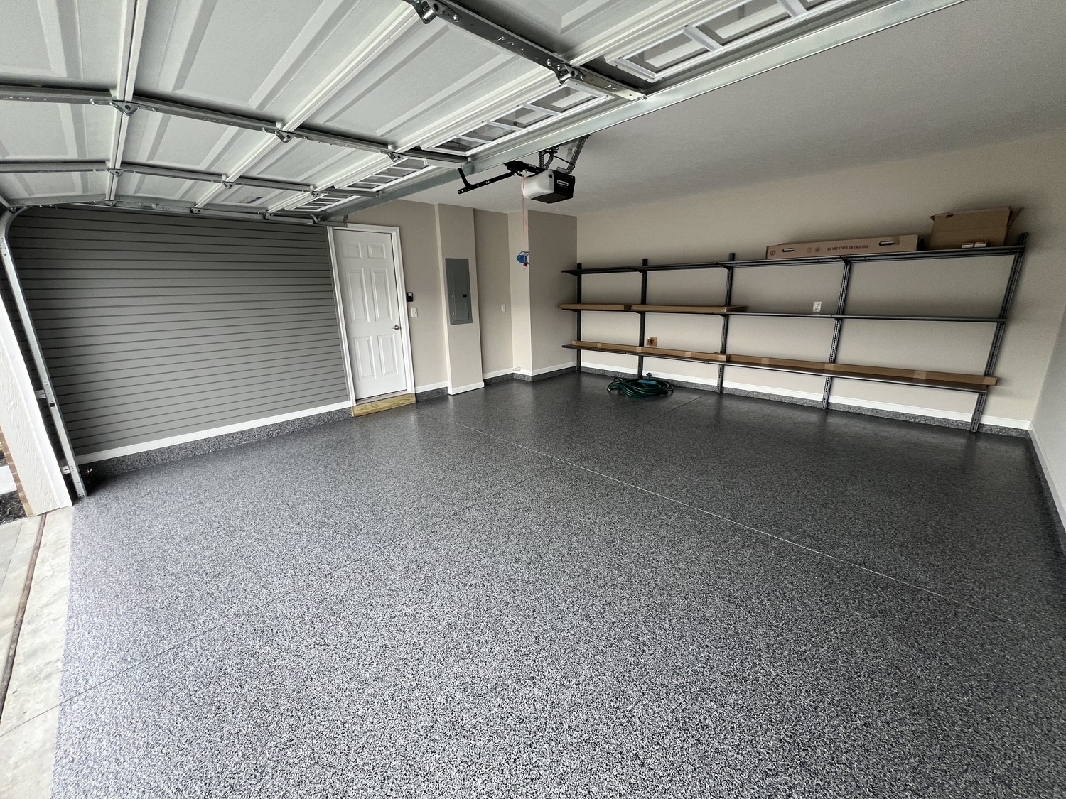 garage with slatwall and shelving