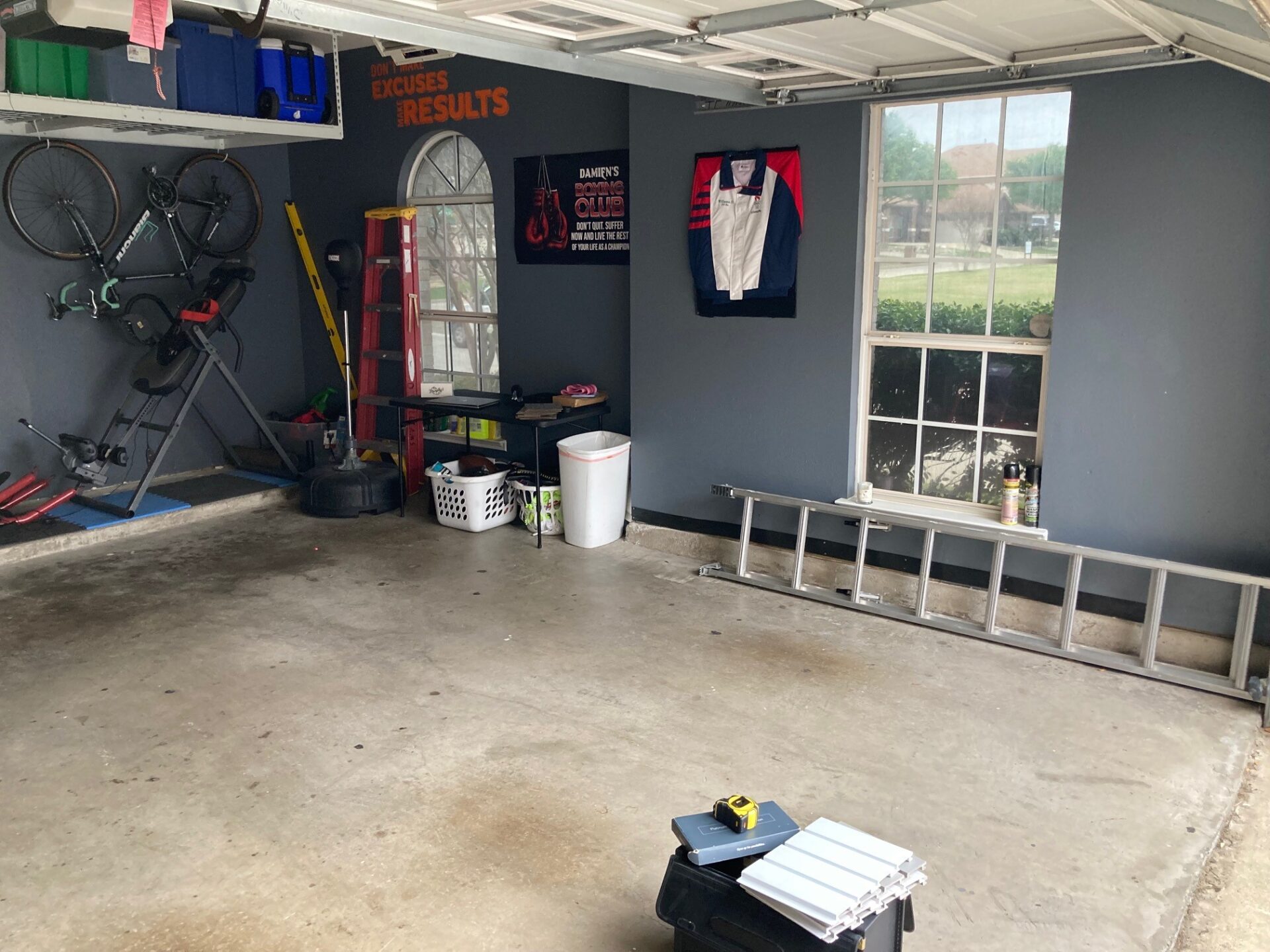 Cluttered garage with bare concrete
