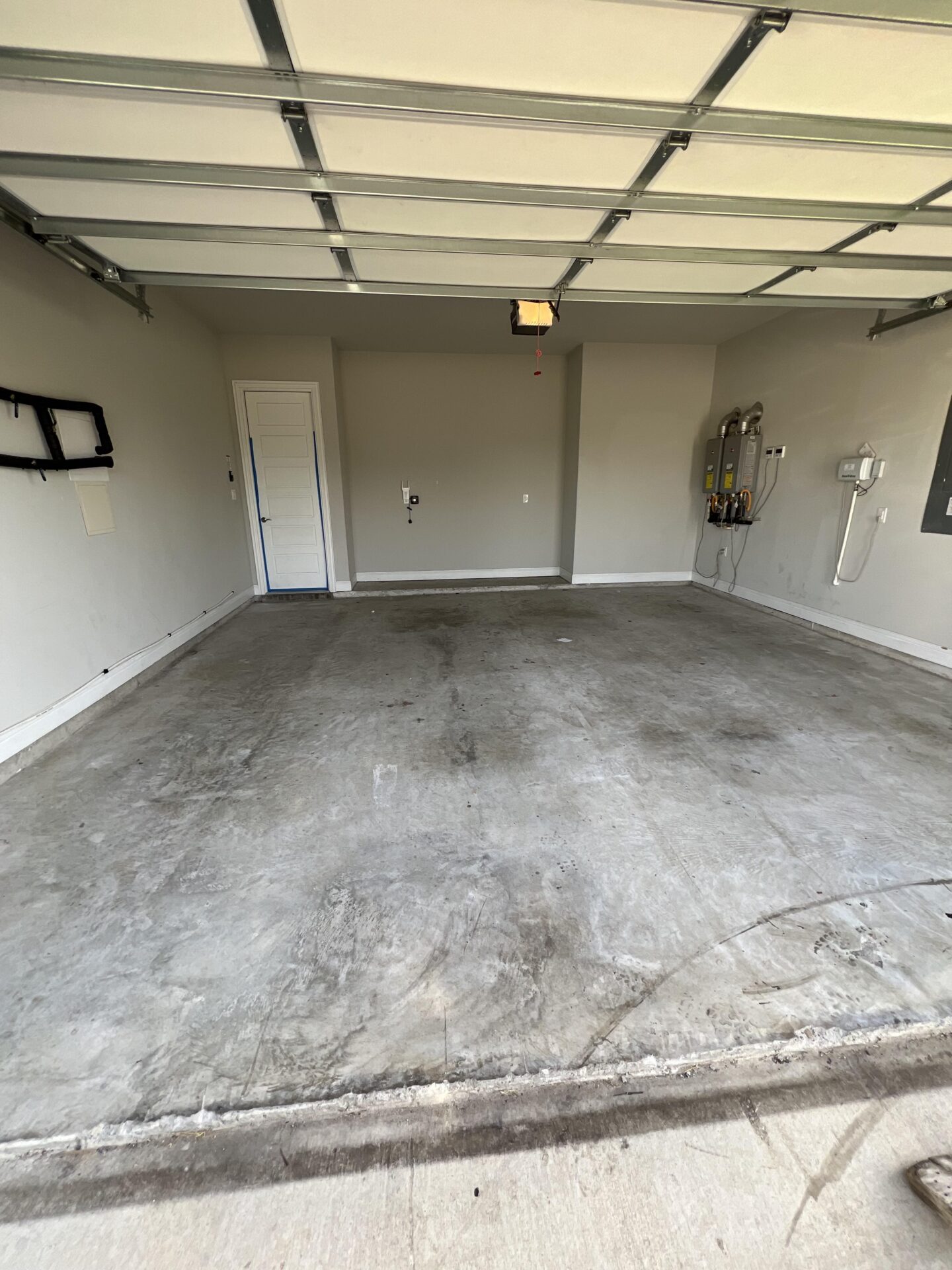 Dingy stained concrete flooring in garage