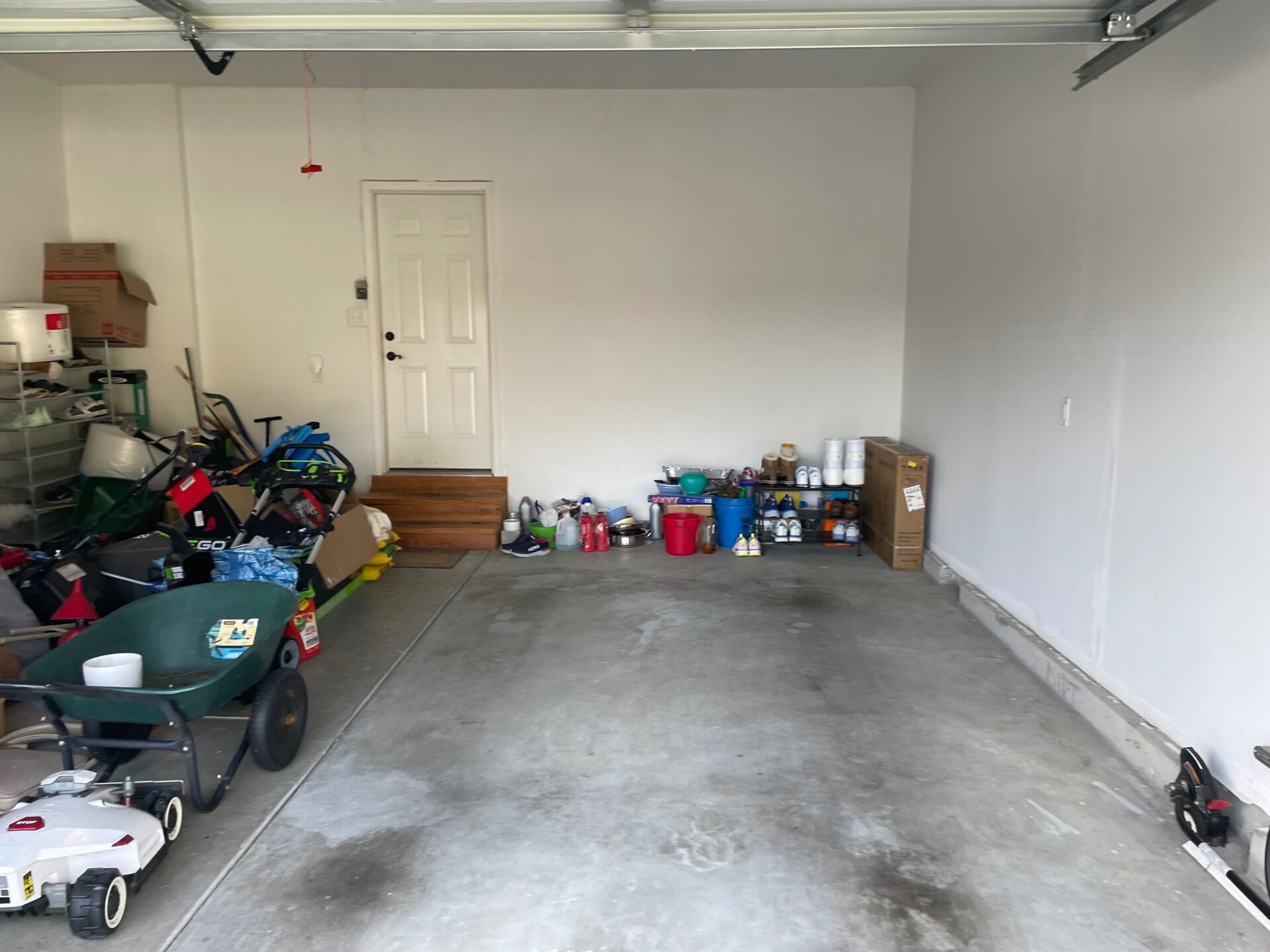 cluttered garage with bare concrete