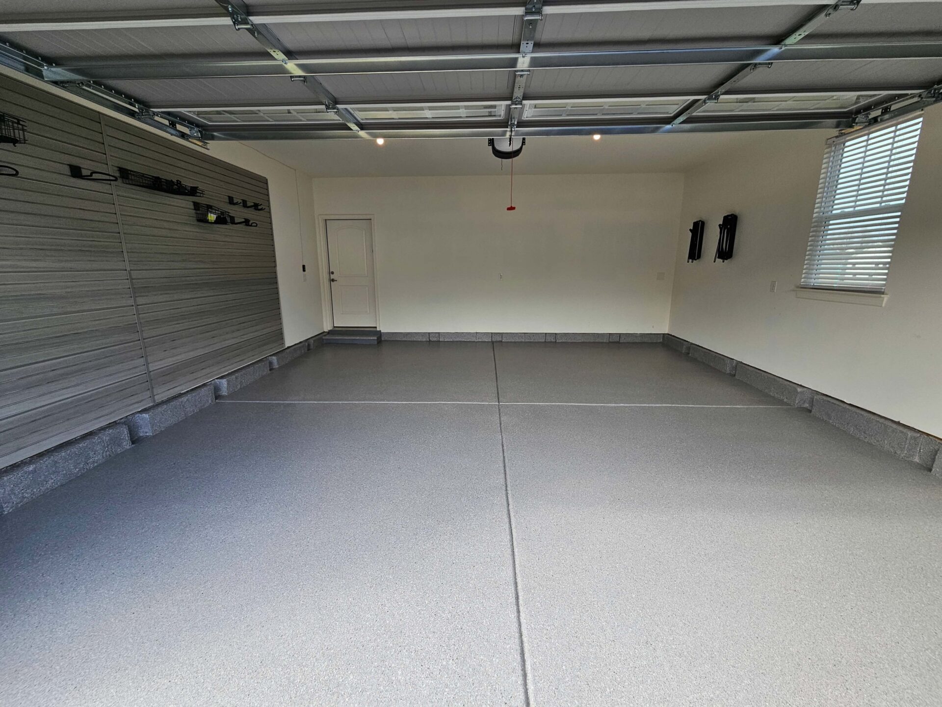 Garage Makeover in Middletown - slatwall and bikehooks and silver flooring