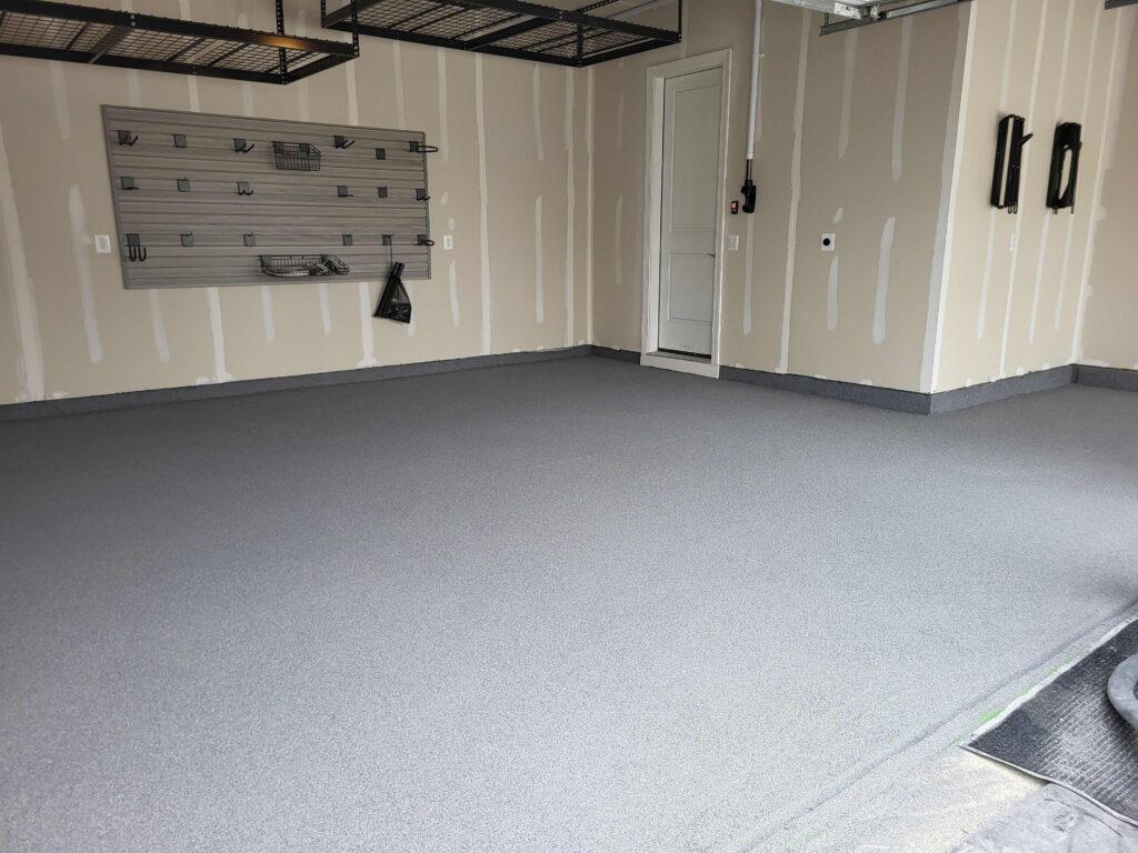 Garage Renovation with new concrete coating, slatwall, bike hooks and overhead storage