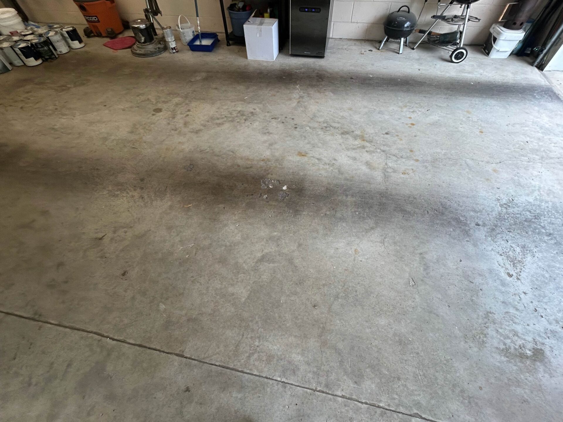 before photo of a stained garage floor in Rehoboth Beach