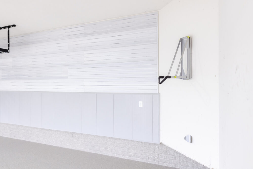 Wall with slatwall and chair rail wall finishing and bike hook