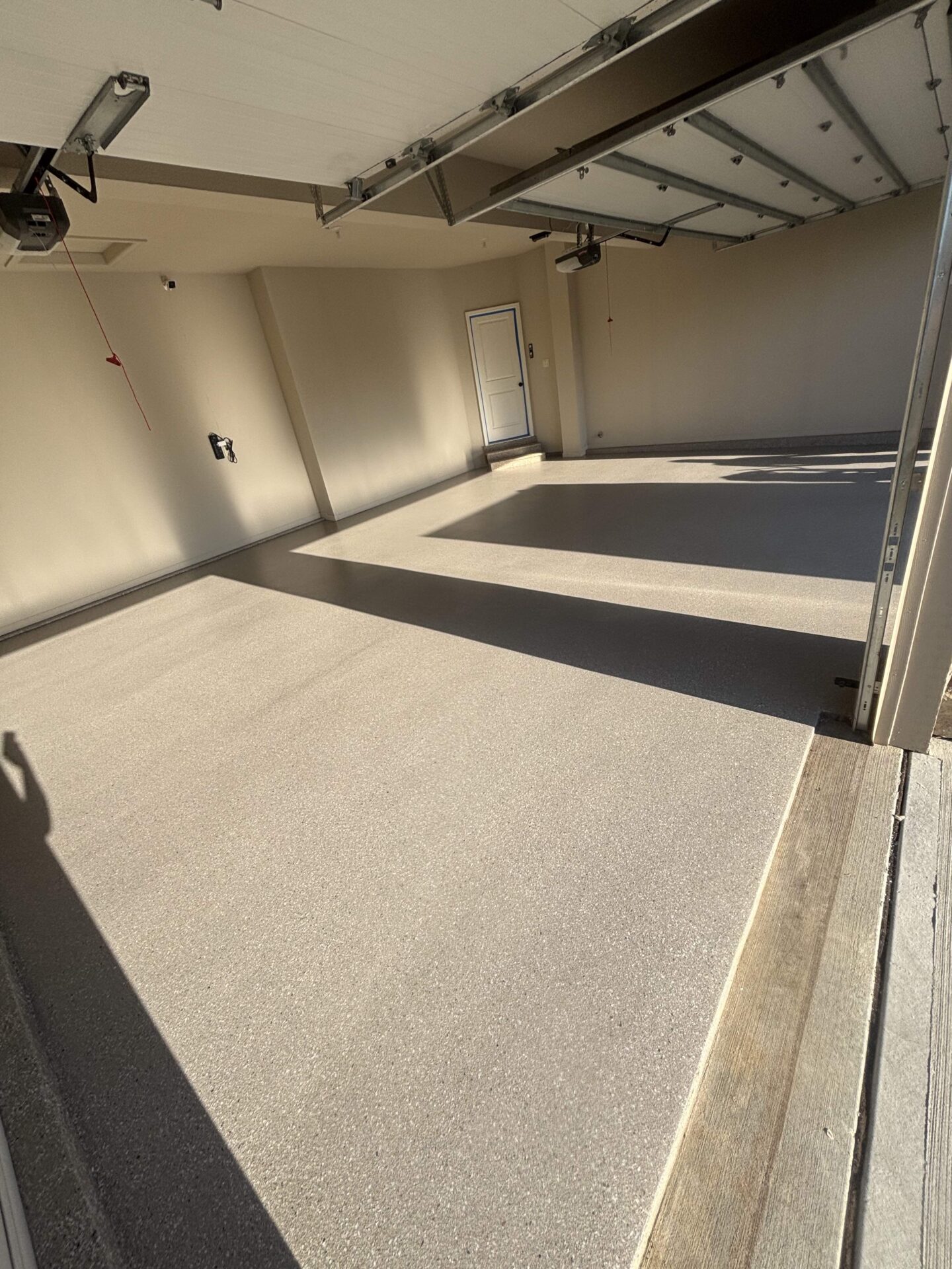 Sleek polyaspartic garage floor coating in bronze