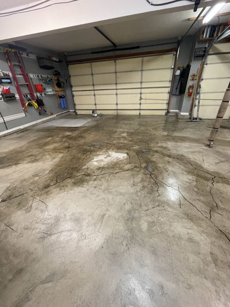 Cracked Garage Floor in Overland Park before polyaspartic coating