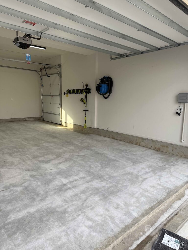 Stained concrete before a concrete coating by Hello Garage in Lenexa Kansas
