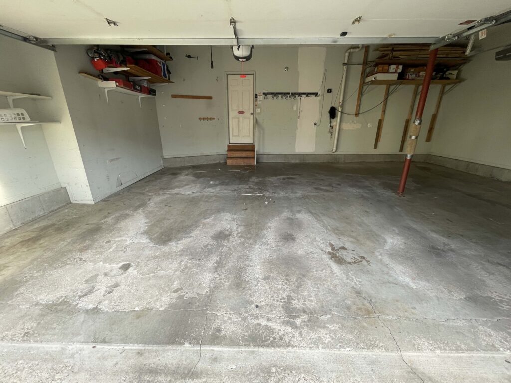 Stained cracked garage floor in Olathe