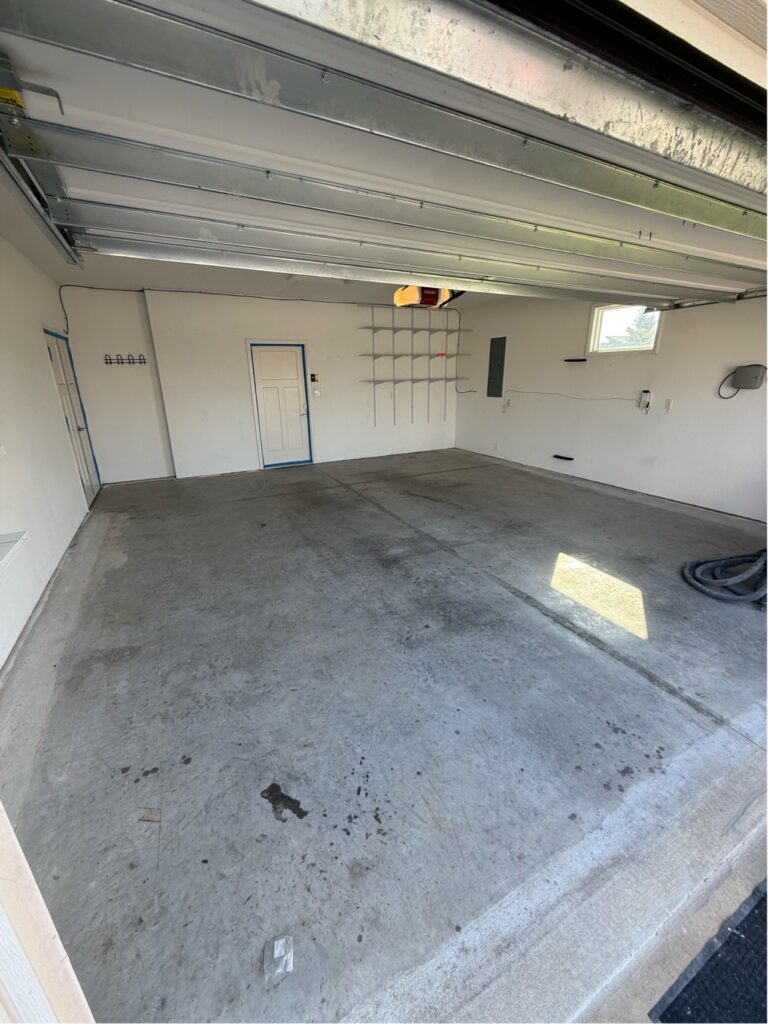 garage with peeling epoxy before garage floor coating in lawrence