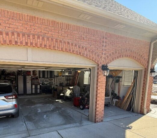Cluttered garage with bare concrete
