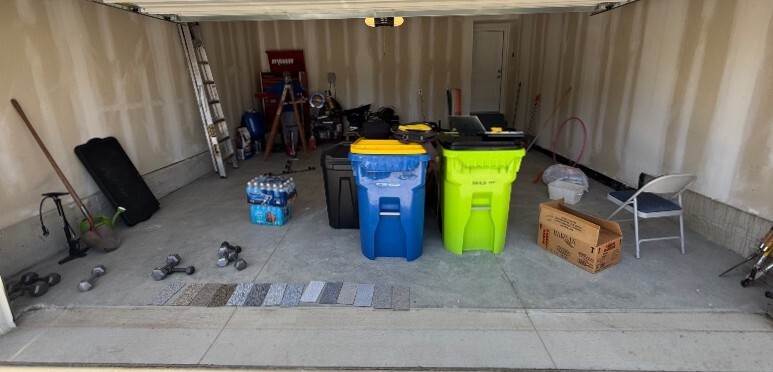 Cluttered garage with bare concrete
