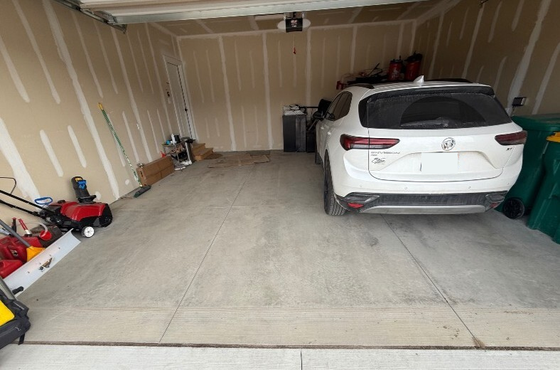 cluttered garage with bare concrete