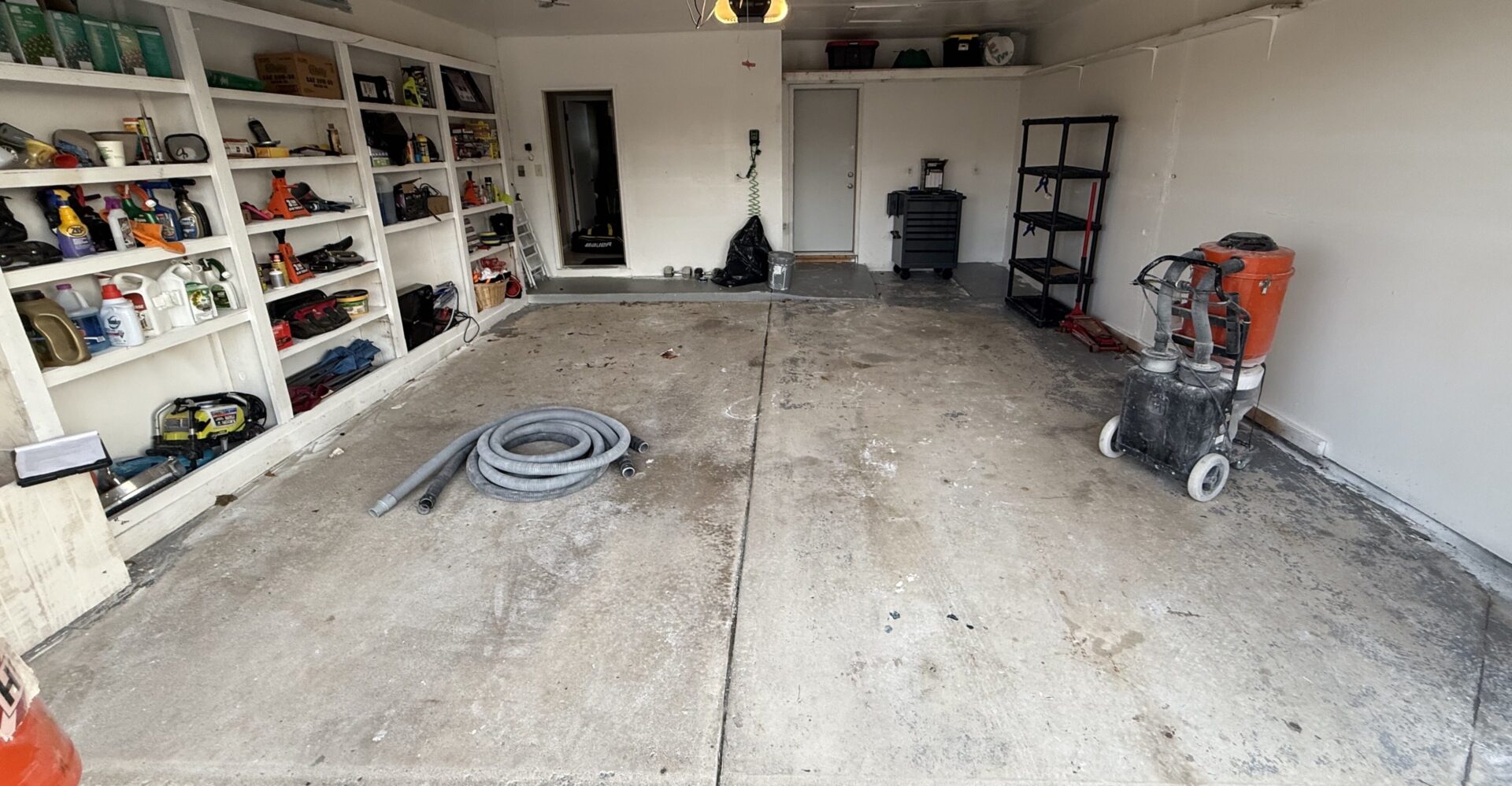 cluttered garage with bare concrete
