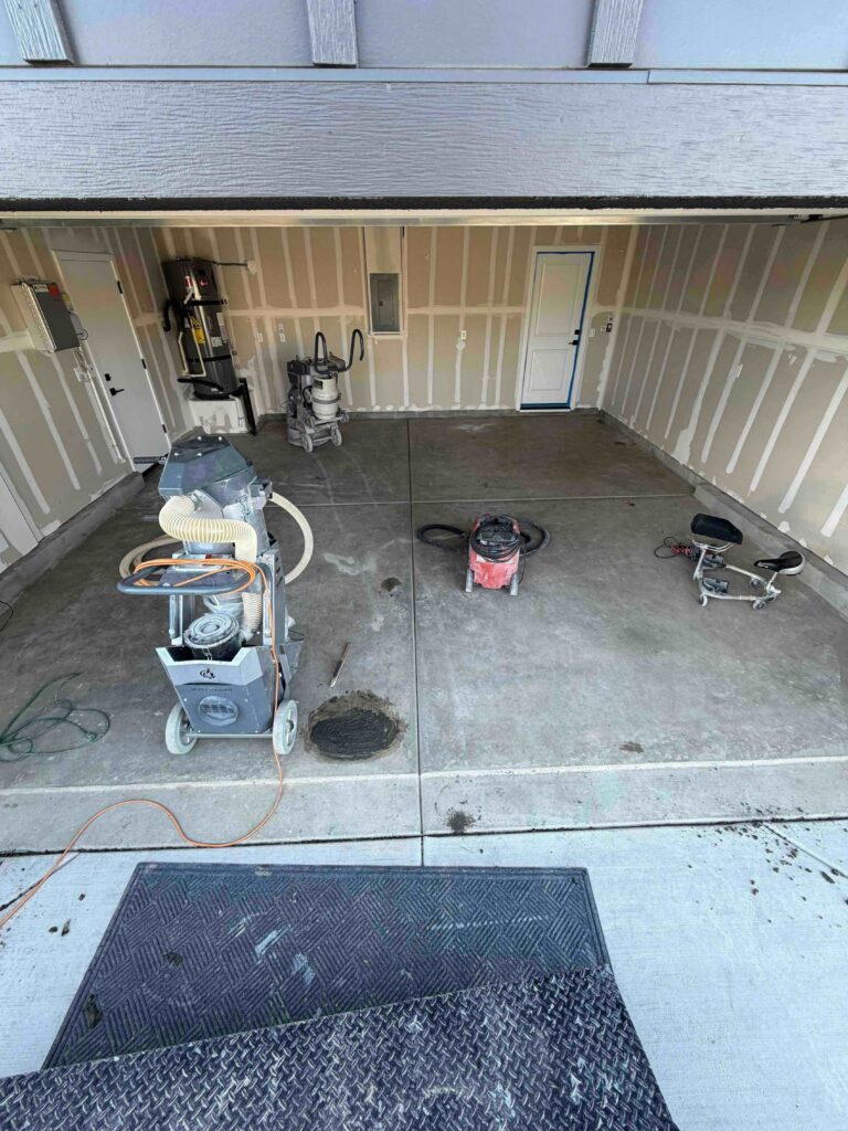 Garage Floor with concrete grinding equipment before a flooring installation in Dixon