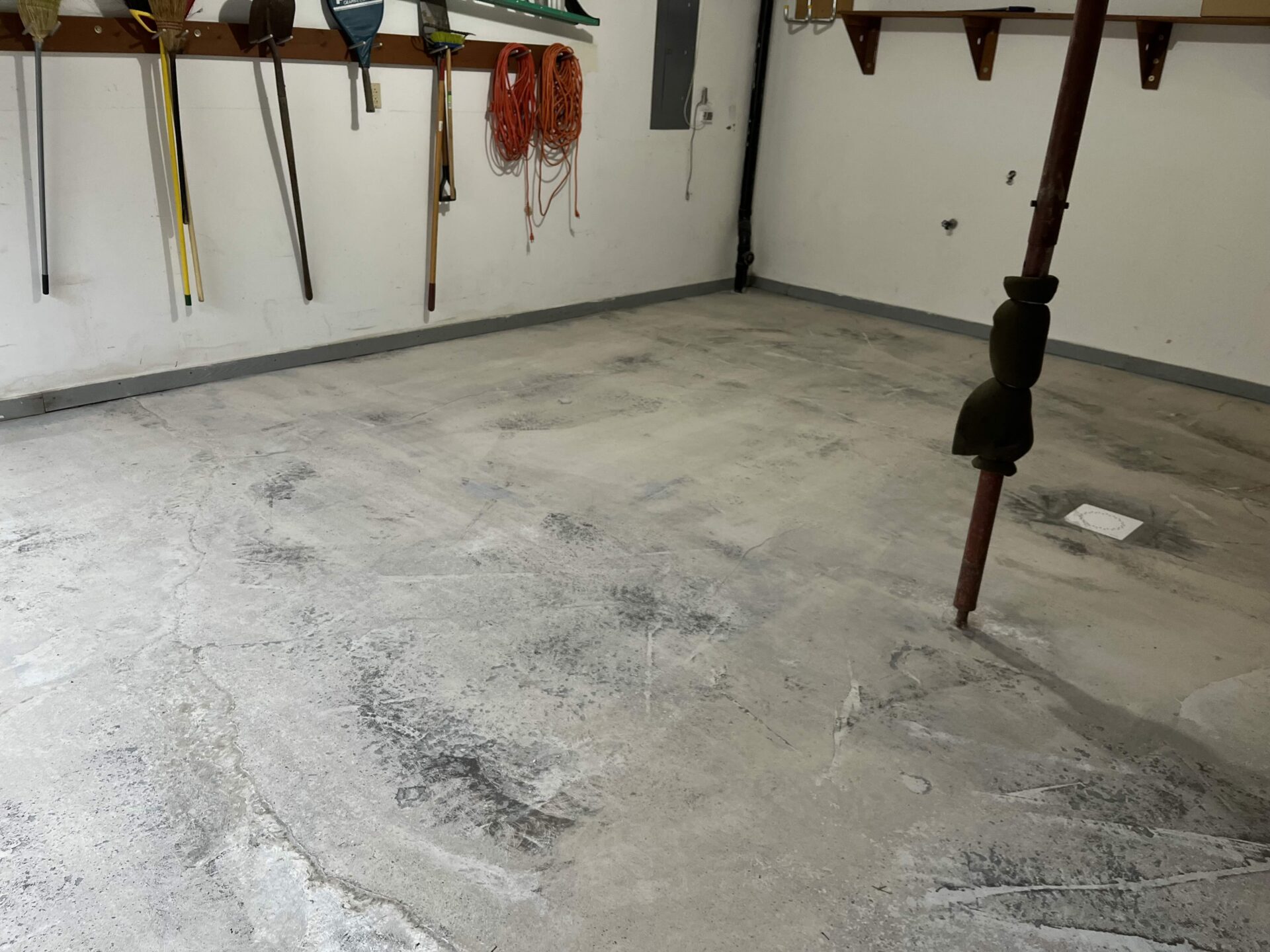 Bare Concrete in a garage with a lot of stains from oil and cracks from salt in Cranberry Township