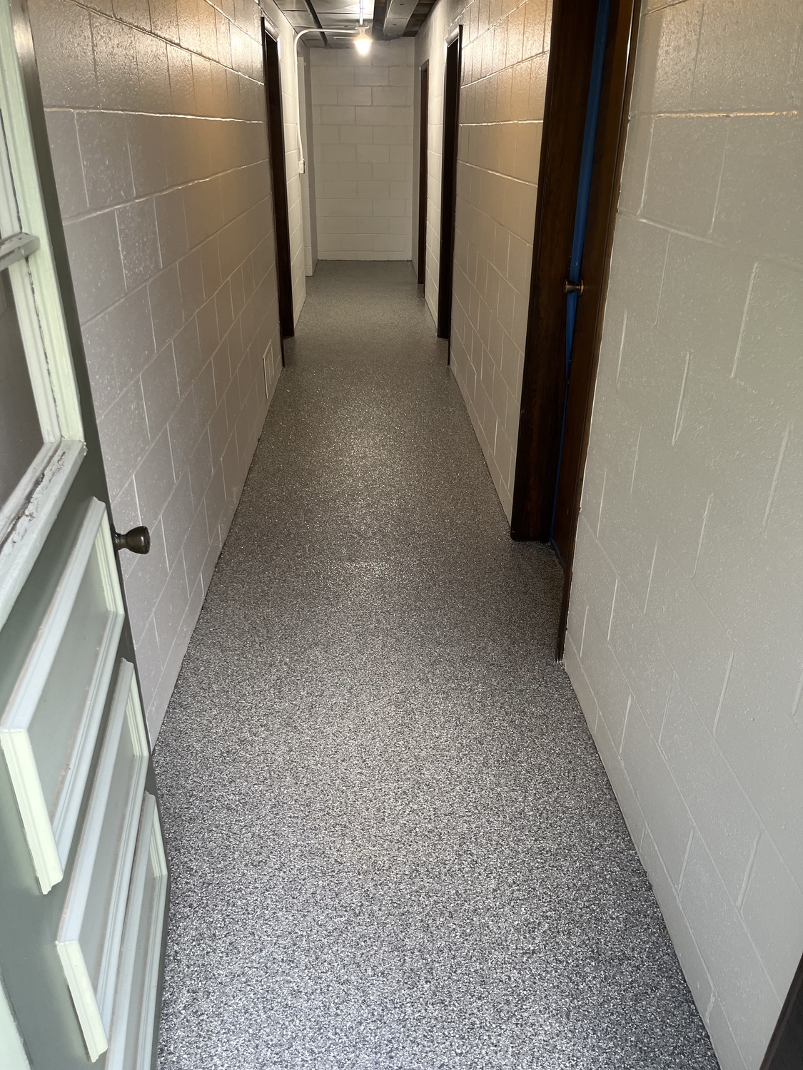 Commercial Hallway with new polyaspartic concrete floor coating in a grey color in New Brighton Pennsylvania