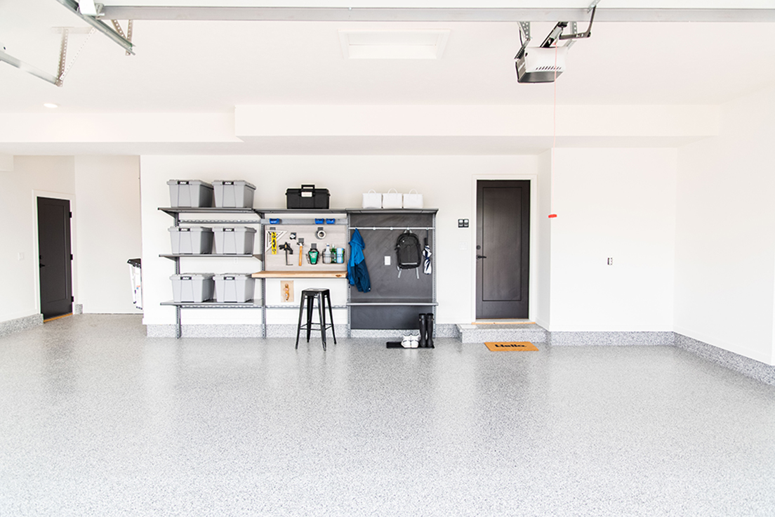Clean garage with storage shelves and totes