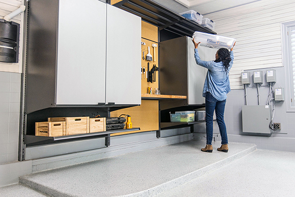Person putting up cabinets in garage