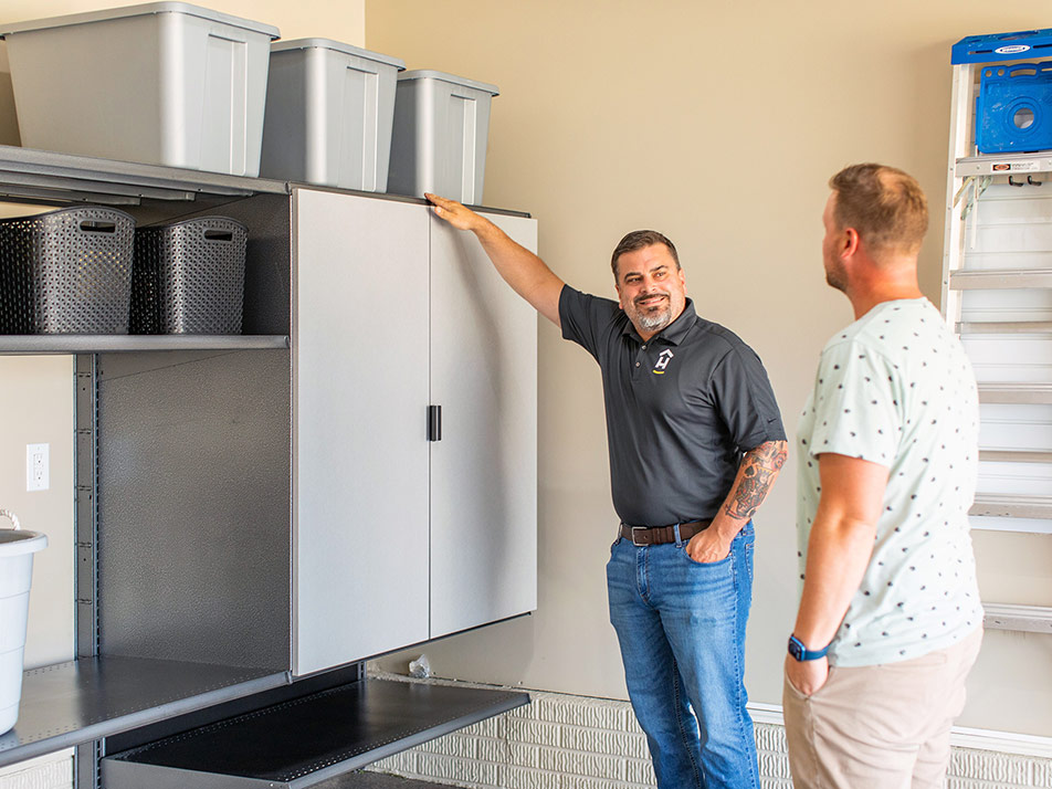 Technician helping customer with garage storage