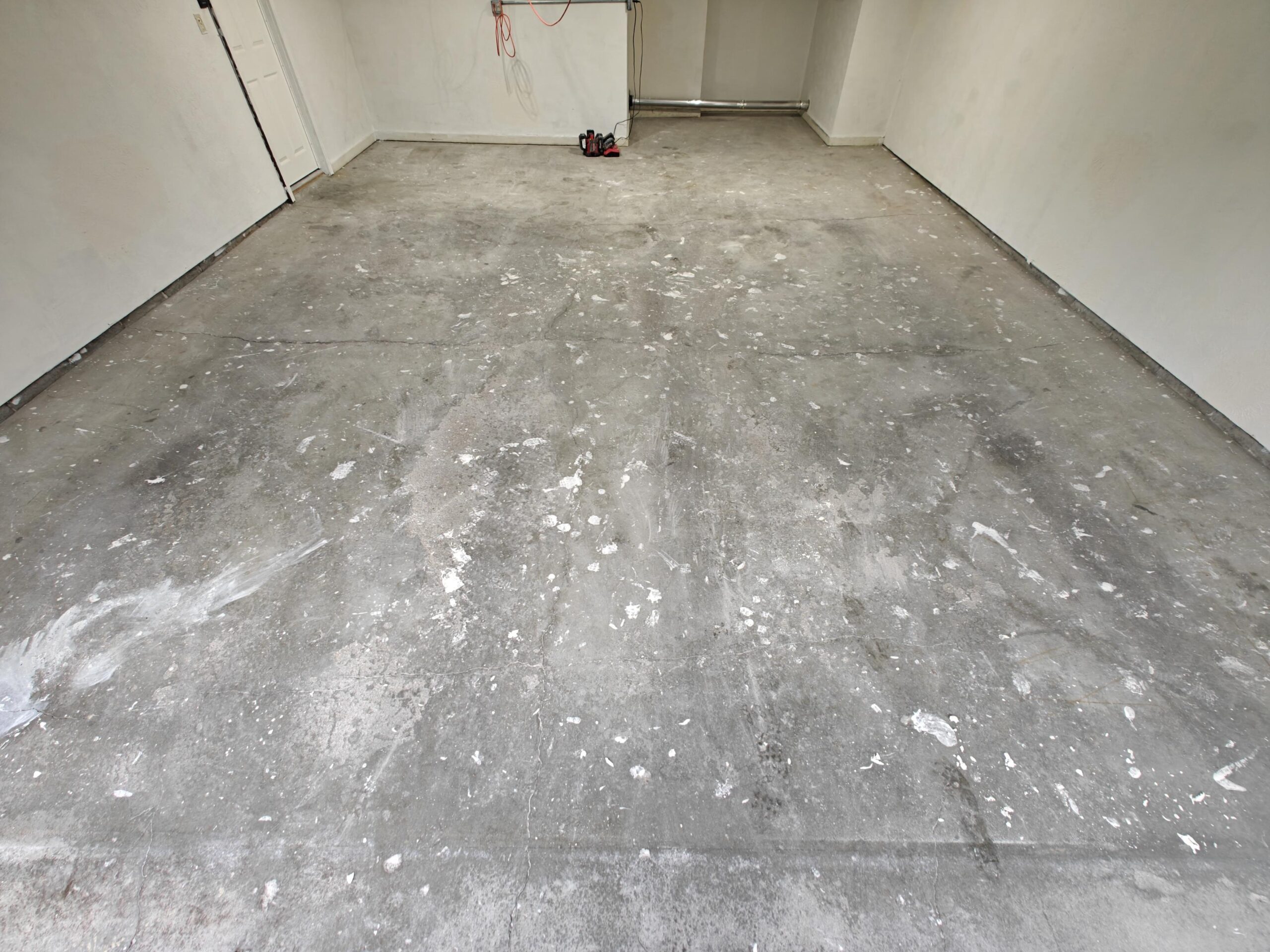 Damaged, pitted garage concrete