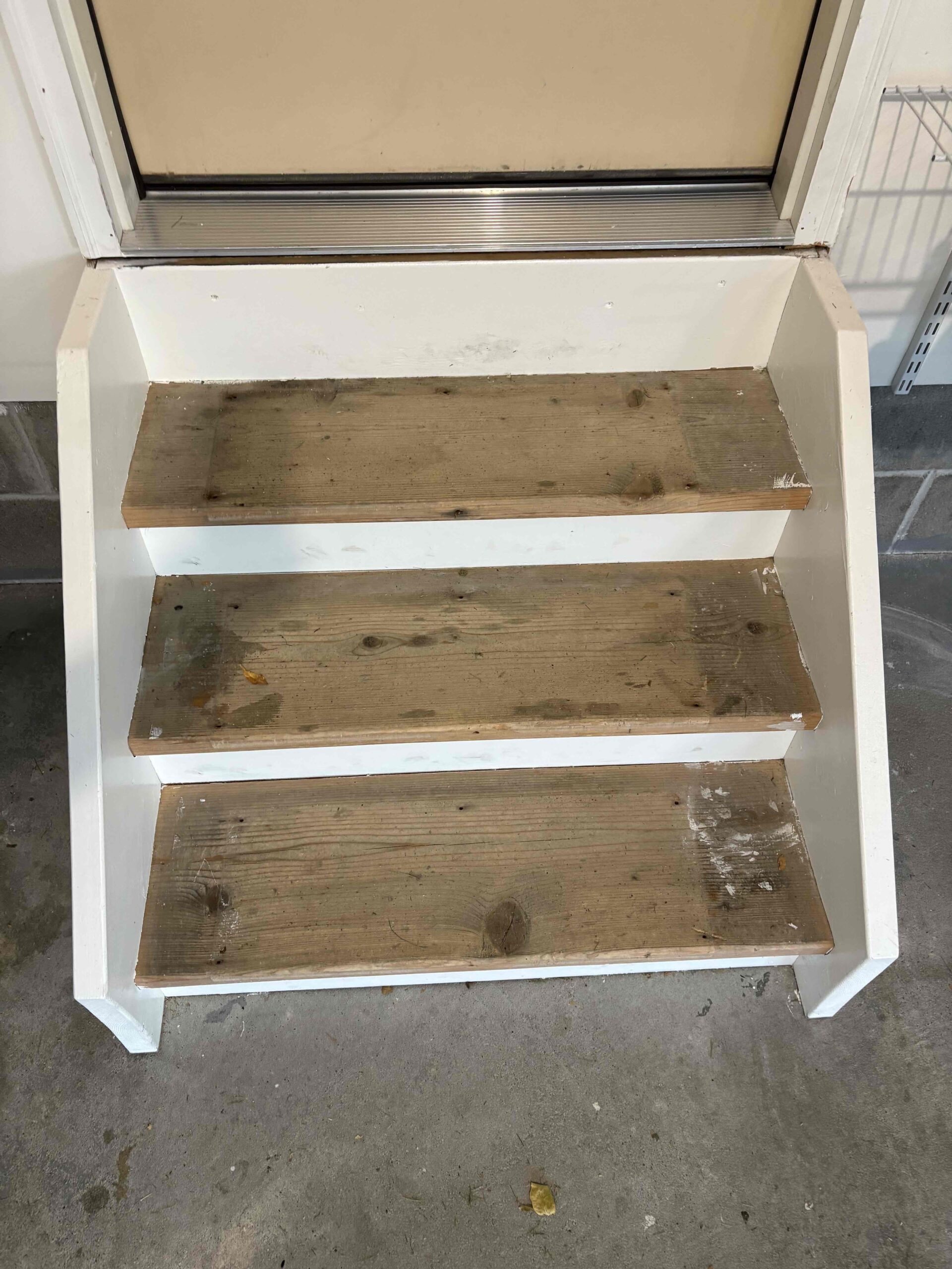 uncoated wood stairs in garage