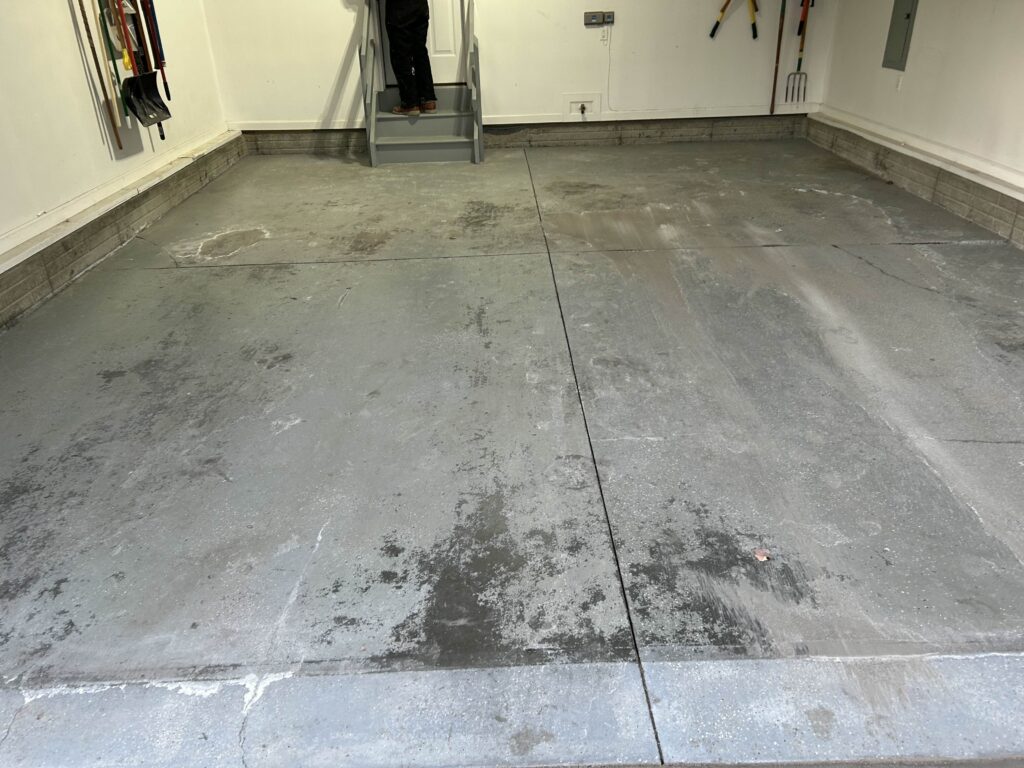 Old Peeling Garage Floor with epoxy on it