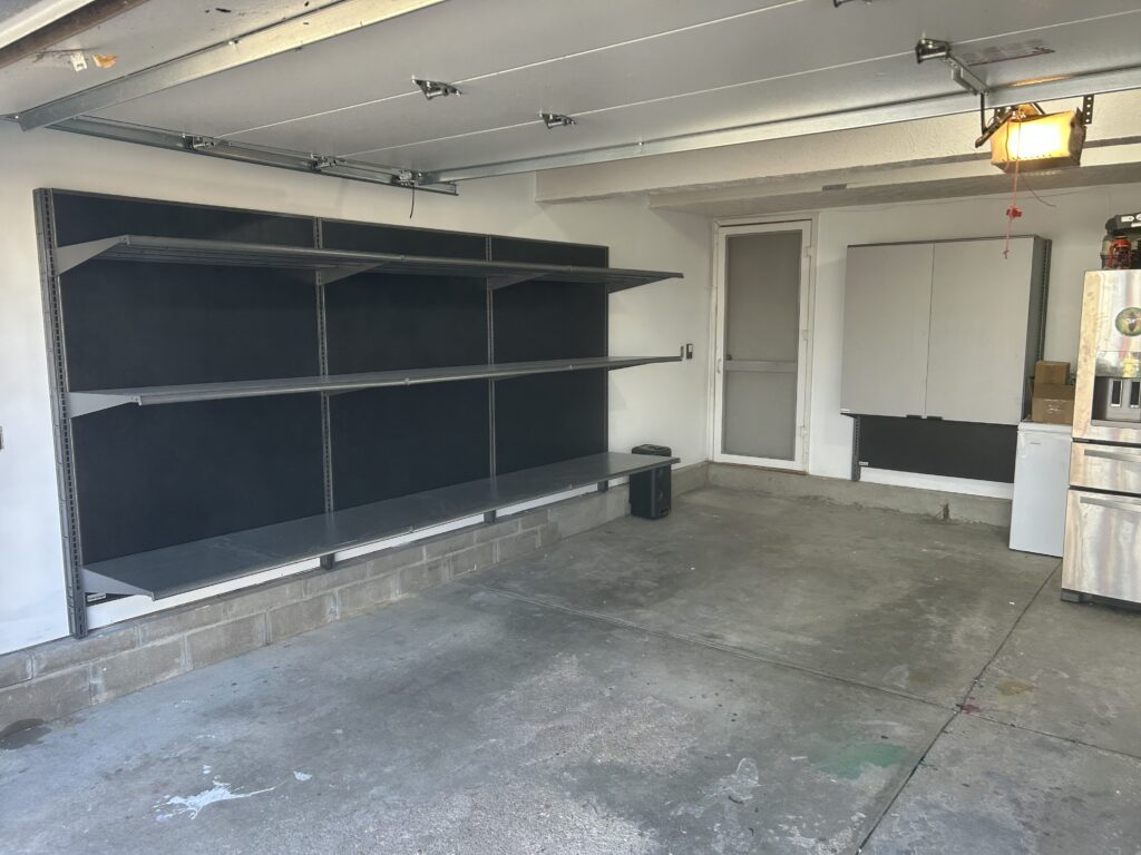 Garage with storage added to it, the storage includes cabinets and shelving