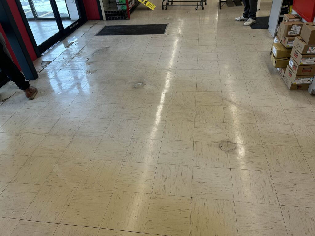 Store Concrete Entrance with a tile on it