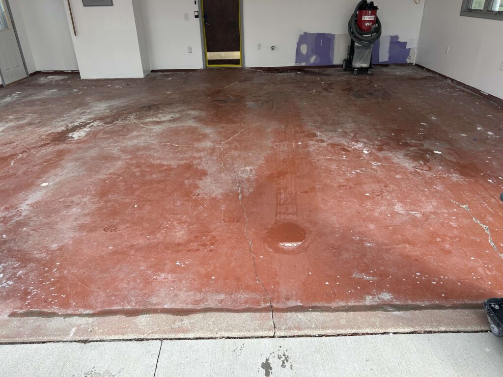 Old red epoxy coating that is stained and peeling