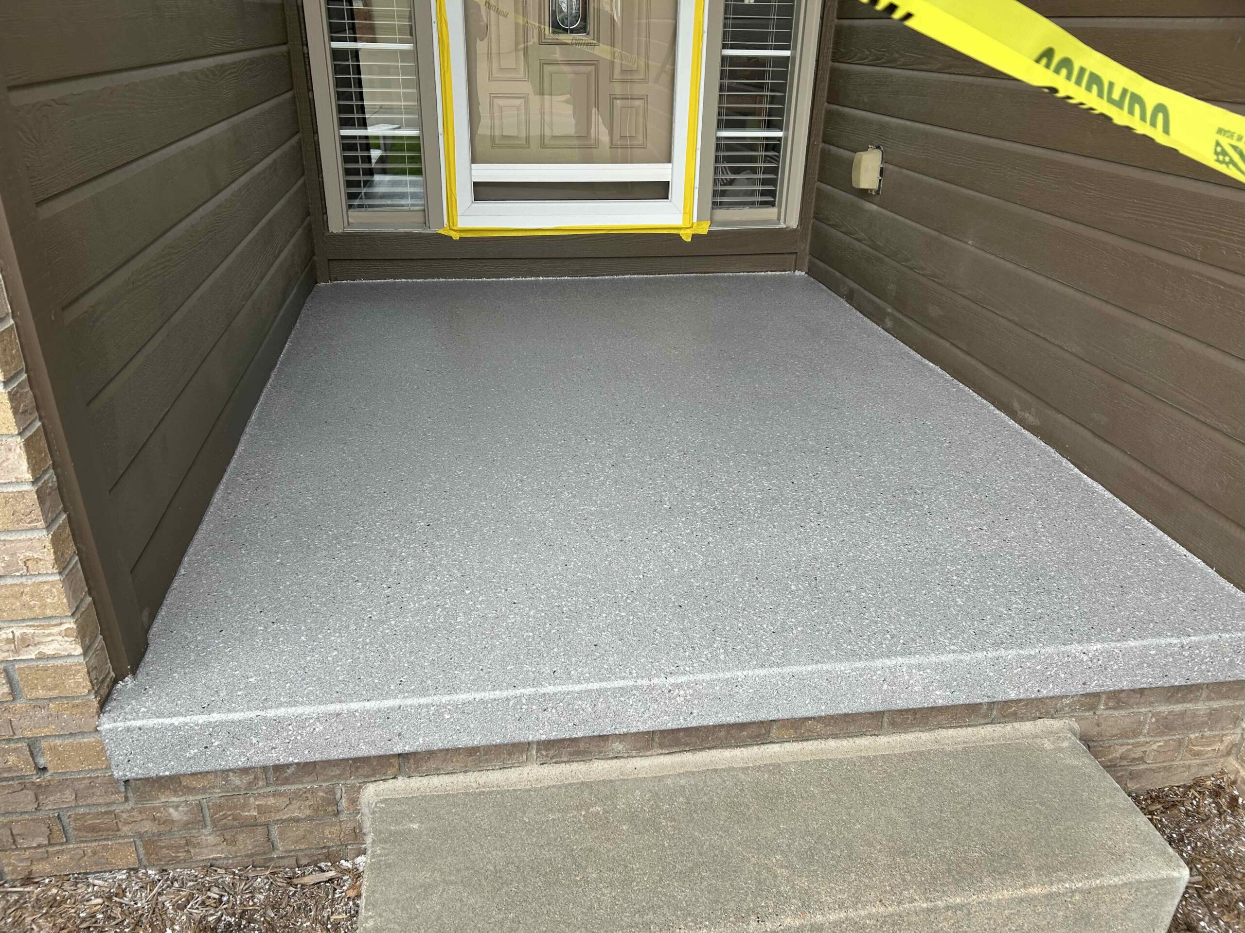 Finished front porch with polyaspartic improving curb appeal in Omaha NE
