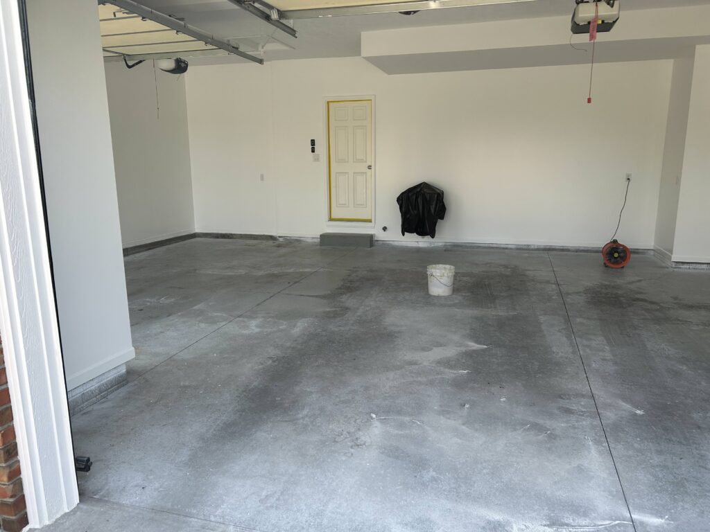 stained garage floor before garage floor coating and garage storage in council bluffs