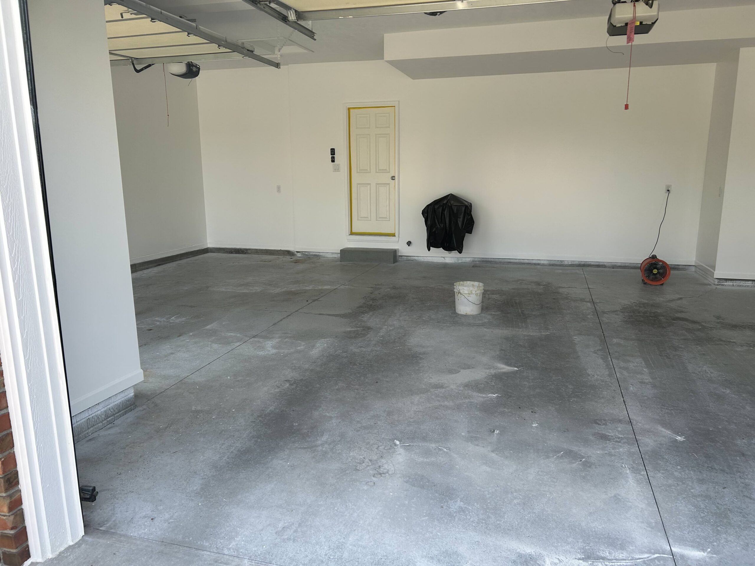 stained garage floor before garage floor coating and garage storage in council bluffs