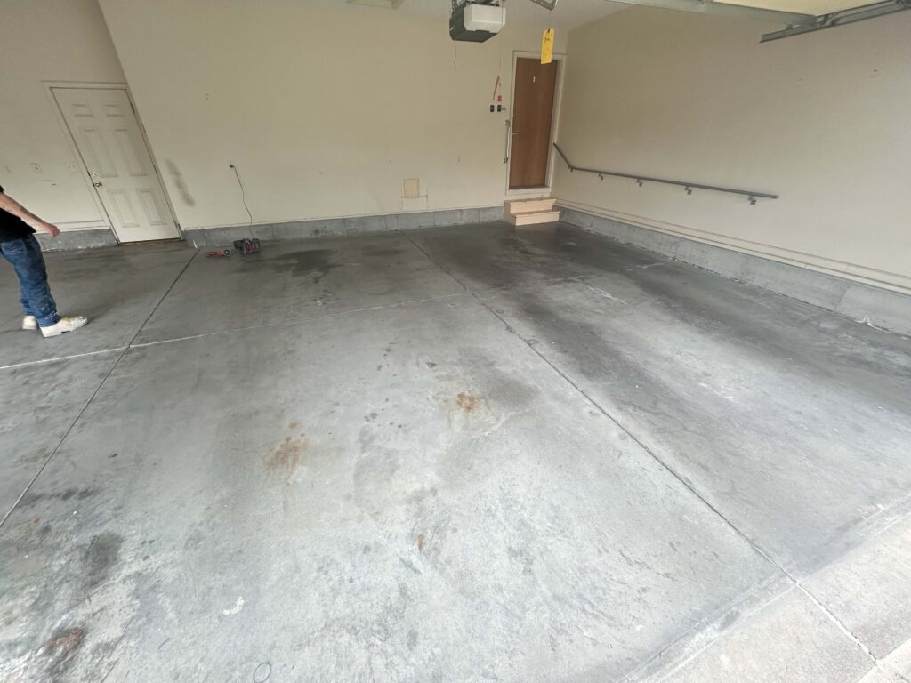 Stained garage floor before in Fremont