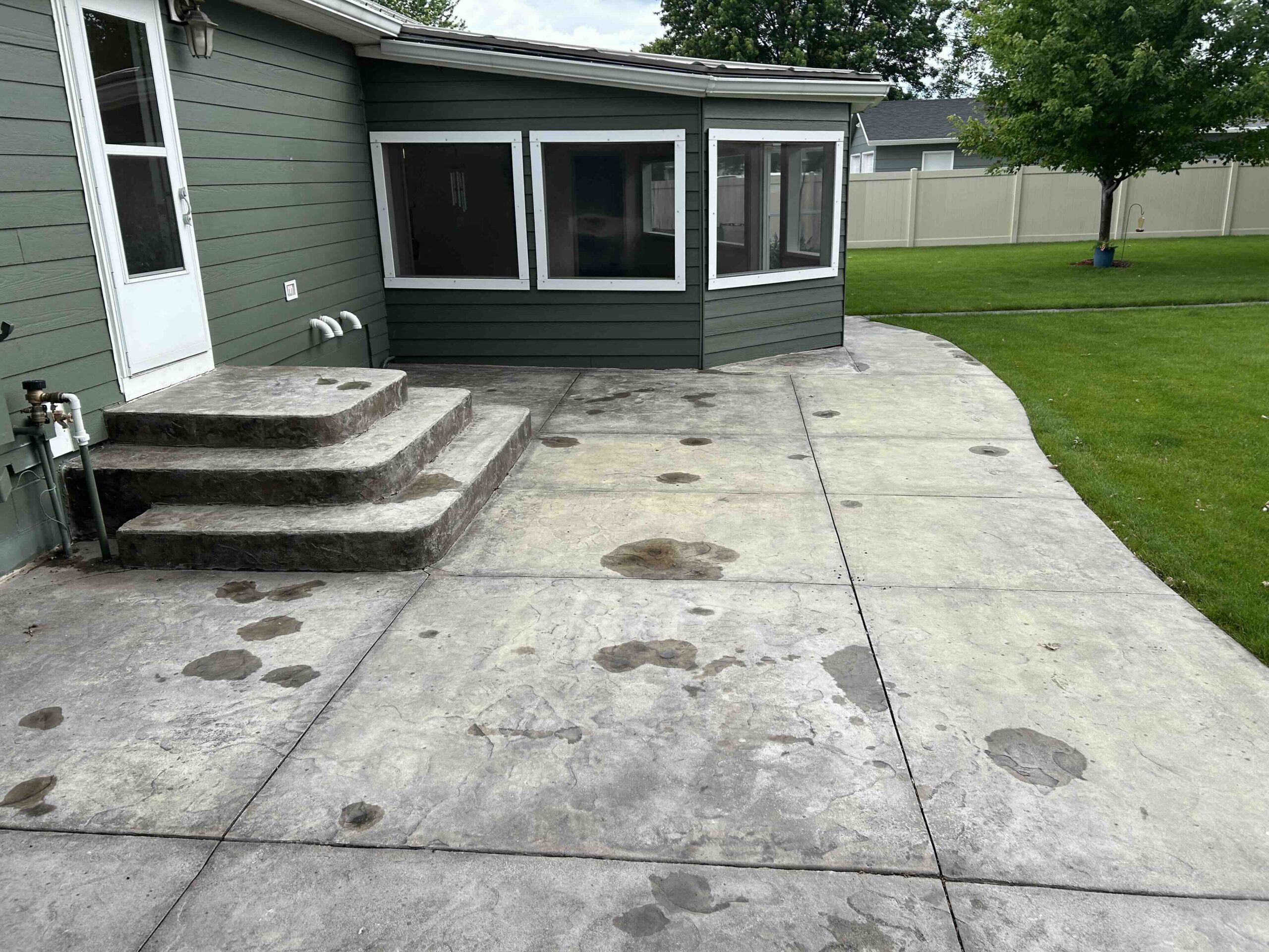stained patio before a concrete coating in lincoln