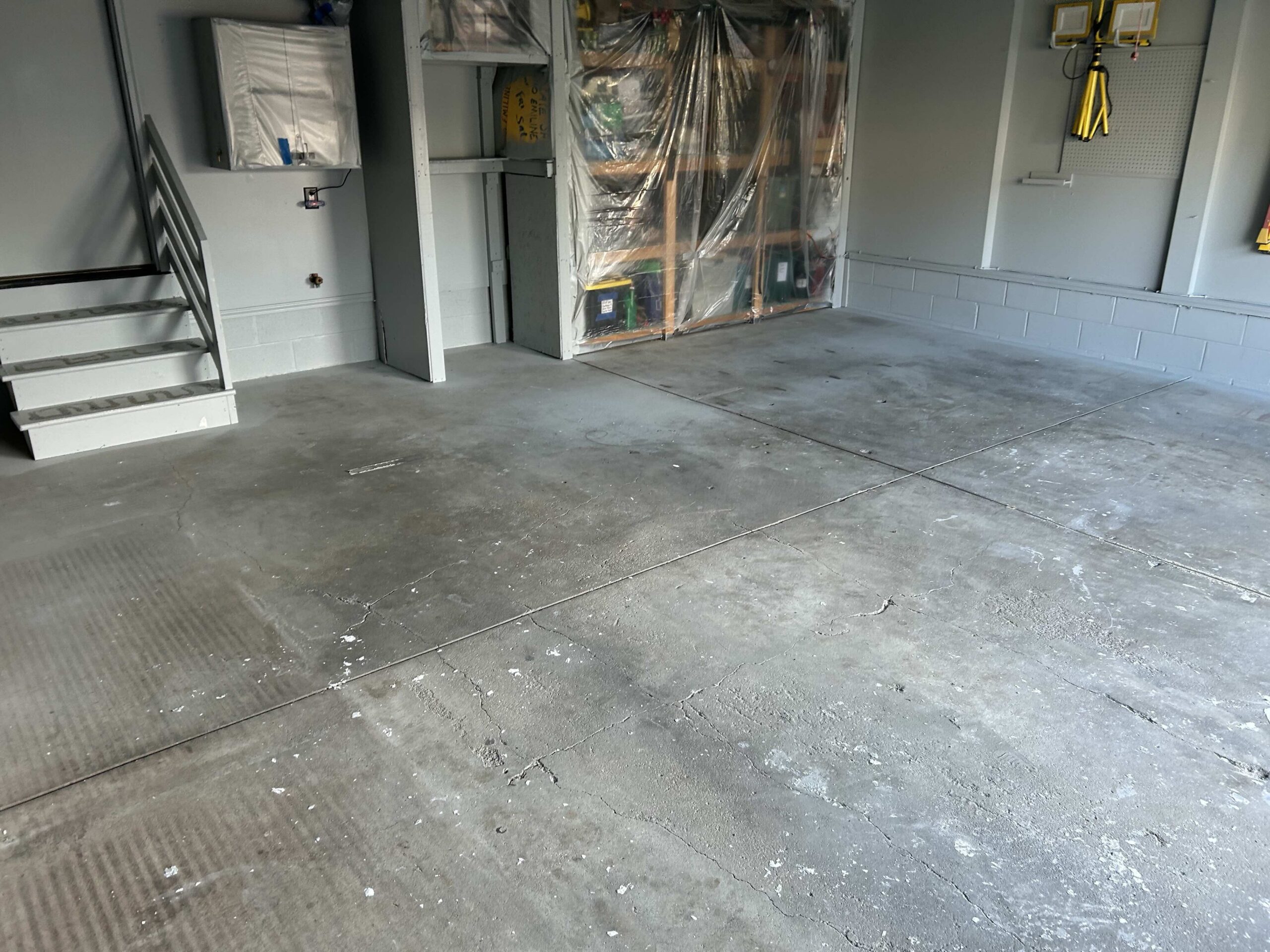 Worn garage floor before a garage floor coating in Plattsmouth NE