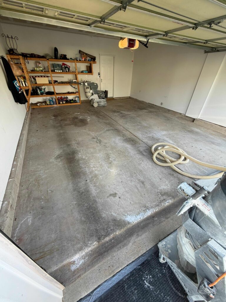 Stained Garage Floor with tiremarks before a garage floor coating