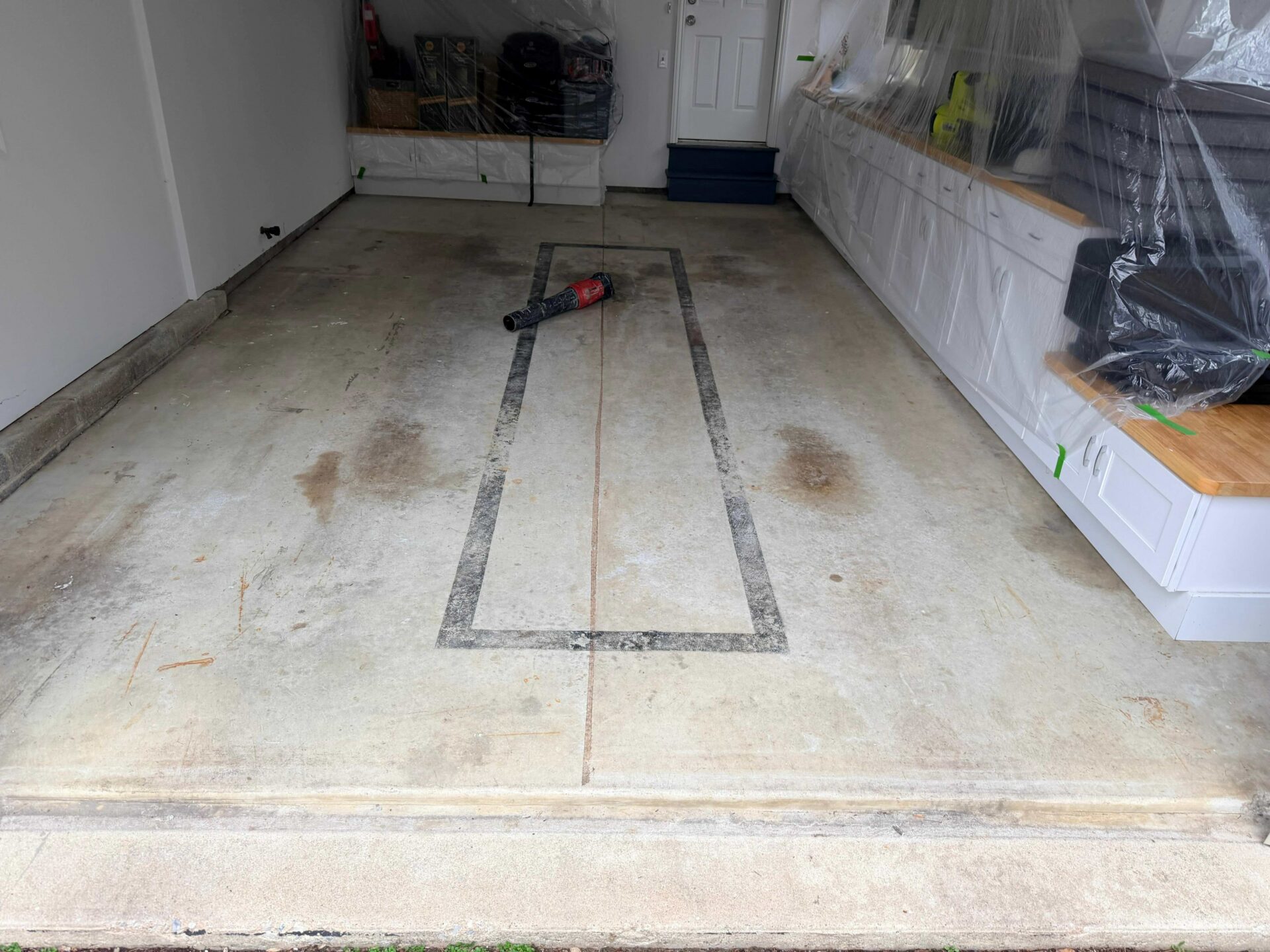stained and pitted garage floor