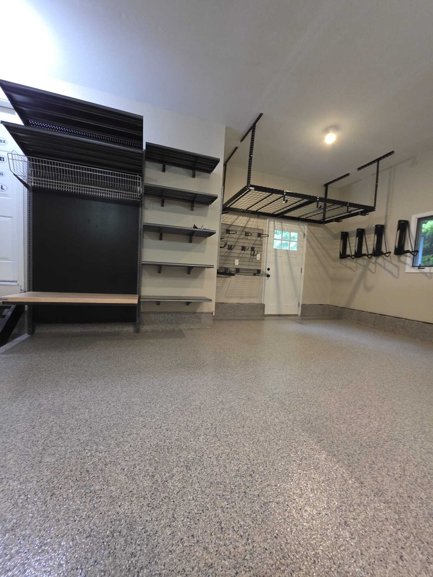 Garage with shelving, overhead storage and bike hooks