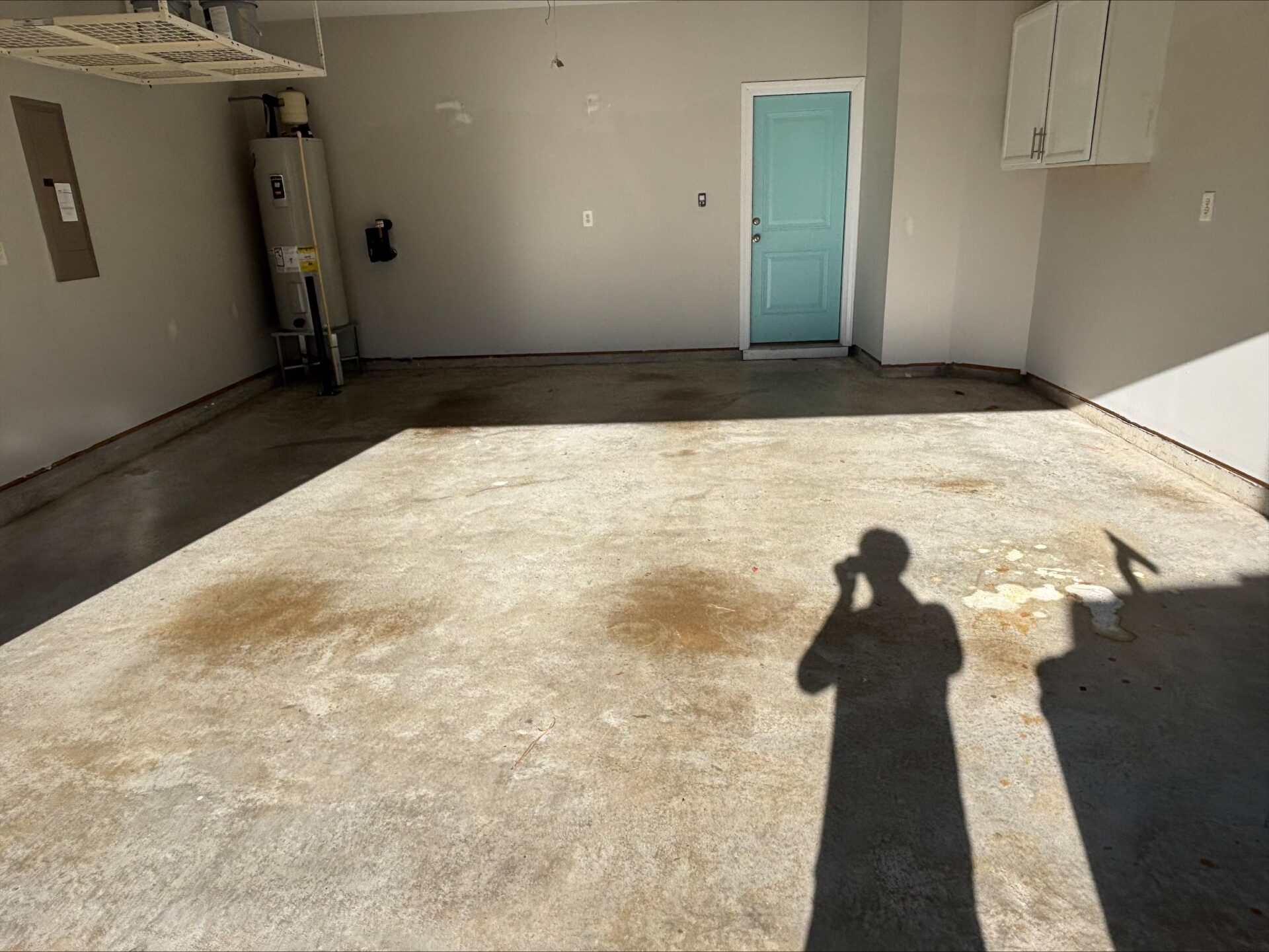 before image of stained, old garage concrete