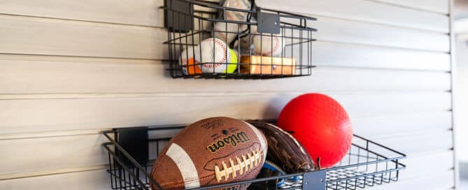 sports equipment hanging from garage slatwall | Hello Garage