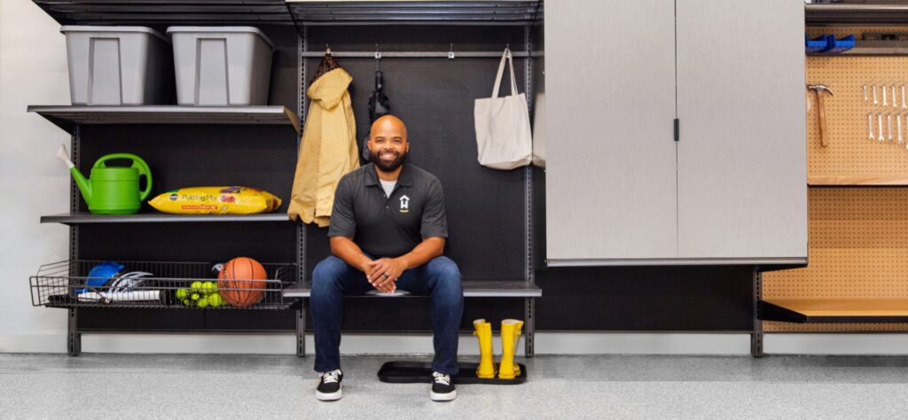 technician in front of garage storage system | Hello Garage