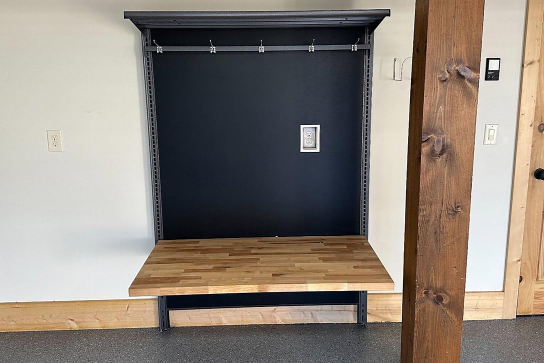 Empty drop zone area with hooks and a wooden bench