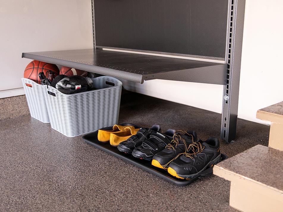 Shoes lined up on drop zone floor with totes