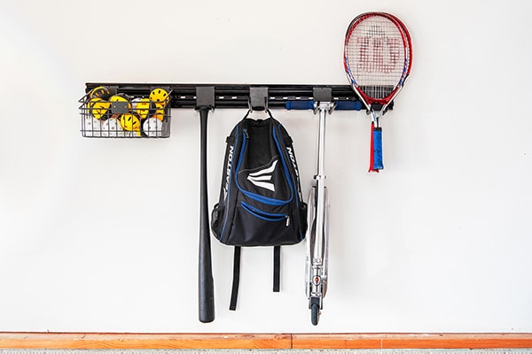 sports equipment hanging from garage wall storage system | Hello Garage
