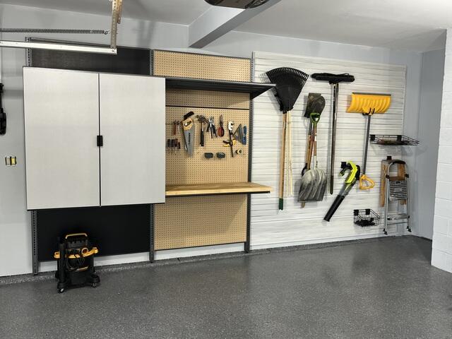 Garage with cabinets, workbench and slatwall