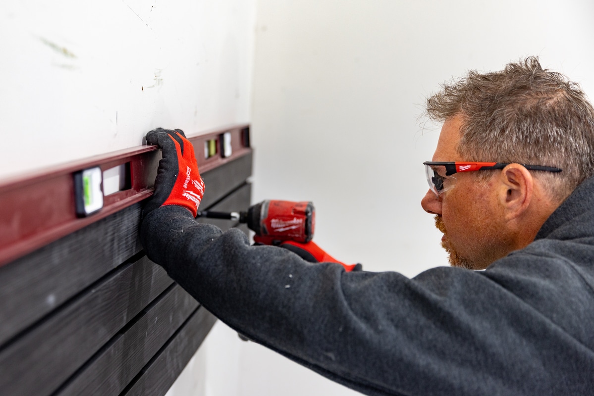 installer putting up slatwall panels